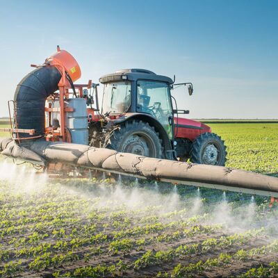 Tractor spreading fertilizer/pesticide